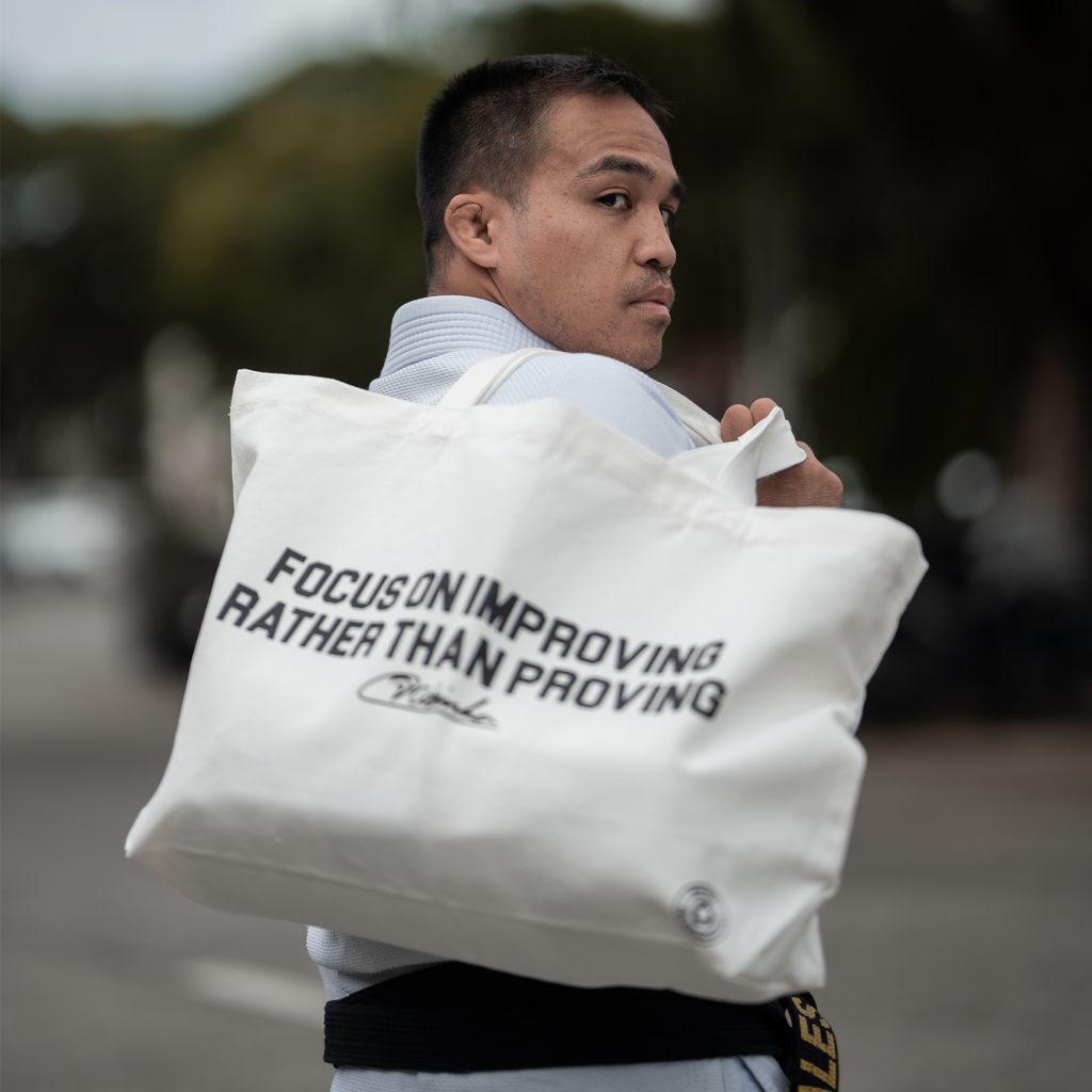 Focus on improving rather than proving Tote Bag