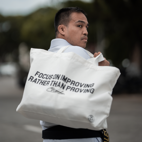 Focus on improving rather than proving Tote Bag