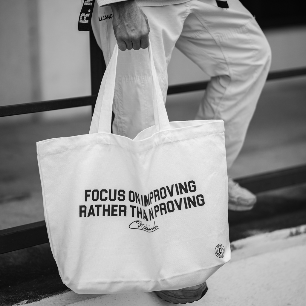 Focus on improving rather than proving Tote Bag